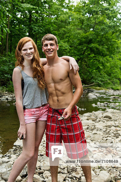 Couple standing by river  portrait