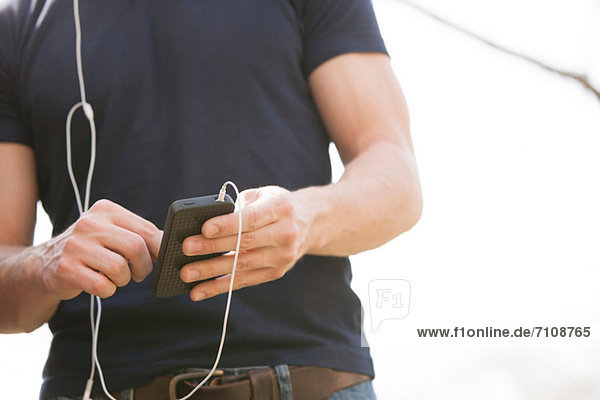 Young man with smartphone and earphones