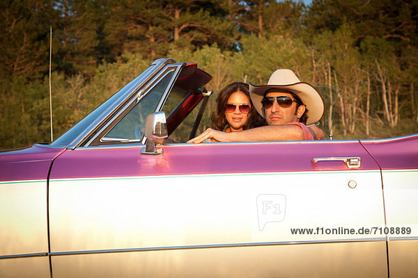 Couple in a convertible car
