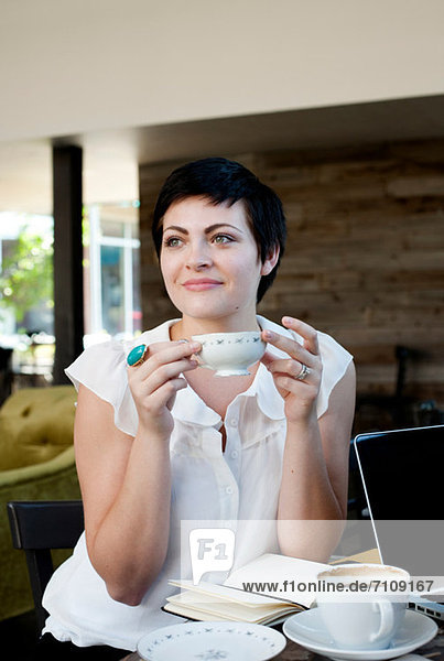 Young woman in cafe with tea
