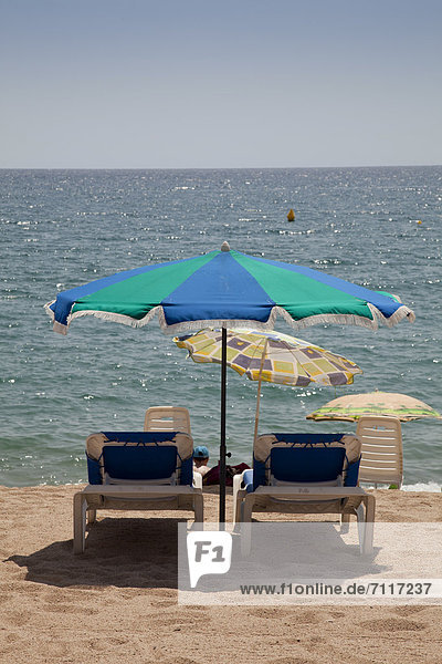 Sun beds and umbrellas on the beach  Blanes  La Selva  Costa Brava  Catalonia  Spain  Europe  PublicGround