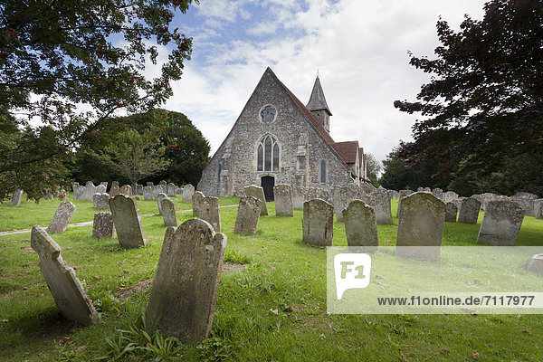 The 12C Church St Thomas ‡ Becket  Warblington and gravestones in the churchyard  Havant  Hampshire  England  United Kingdom  Europe