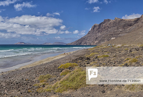 Spain  Lanzarote  Famara  Playa de Famara  landscape  water  summer  mountains  sea  people  Canary Islands