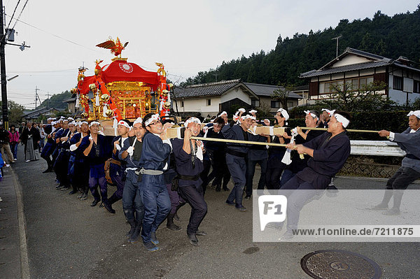 Mobile Shinto shrines are carried through the neighborhood in a procession  Iwakura in Kyoto  Japan  East Asia  Asia