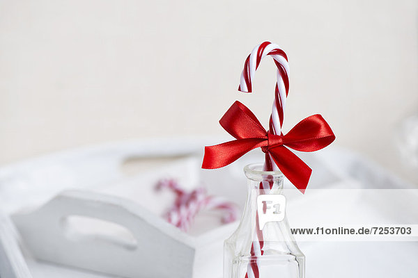 Candy canes with red ribbons