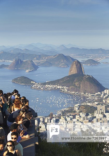 Tourists enjoying view of Sugar Loaf Mountain (Pao de Acucar) and Botafogo Bay from Corvocado  Rio de Janeiro  Brazil  South America