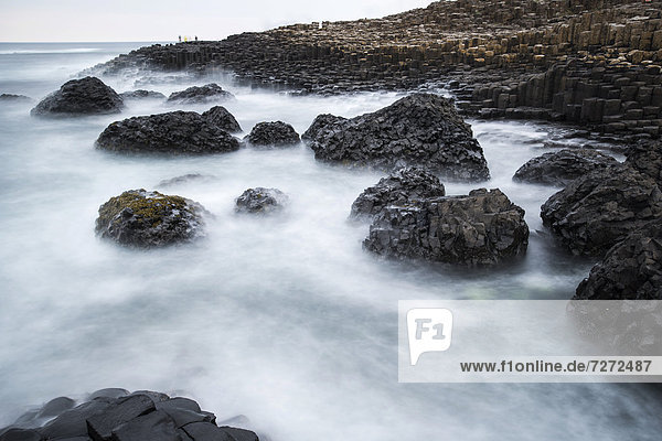 Basaltic rocks on the shore with waves  Giant's Causeway  Coleraine  Northern Ireland  United Kingdom  Europe