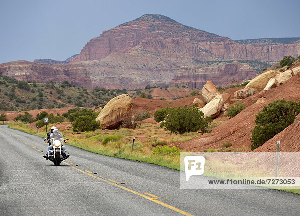Motorcycle driving on the U.S. Highway 24  Waterpocket Fold  Capitol Reef National Park  Utah  Southwestern USA