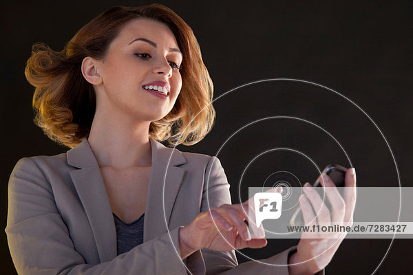 Businesswoman using smartphone touch screen with circles
