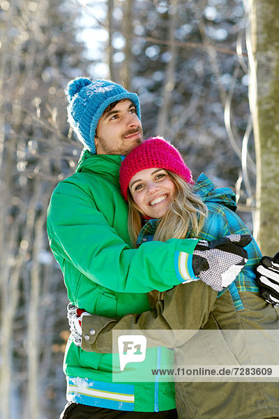Portrait of couple hugging  wearing winter clothes