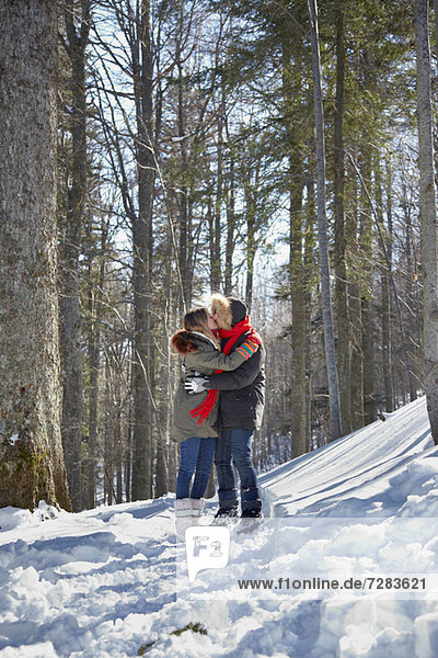 Couple kissing in snow