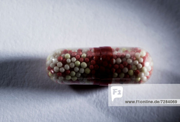 Capsule containing tiny pills