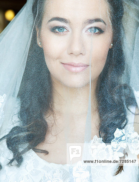 Smiling bride wearing veil