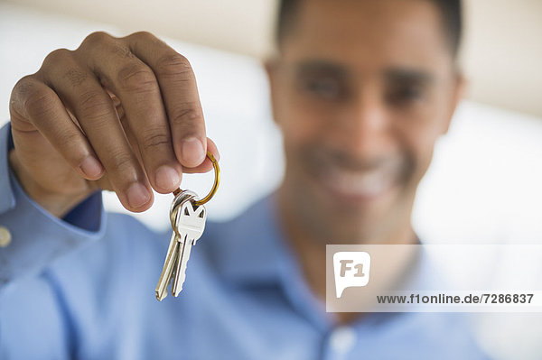 Close up of man's hand holding home key