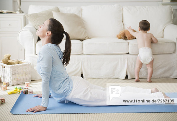 Mother with daughter (6-11 months) doing relaxation exercise