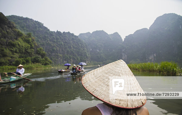 Vietnam  Ninh Binh  Young tourist on river boar in Tom Coc