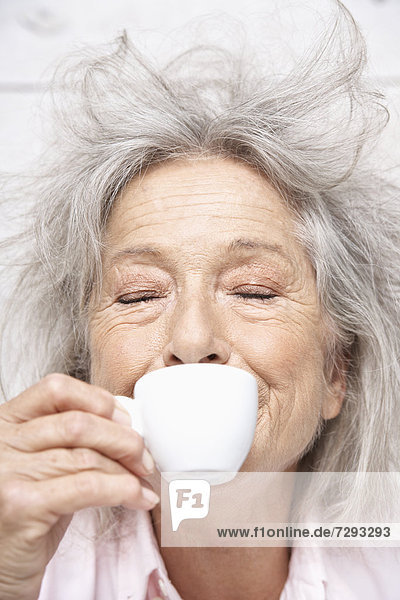 Spain,  Senior woman drinking coffee,  close up