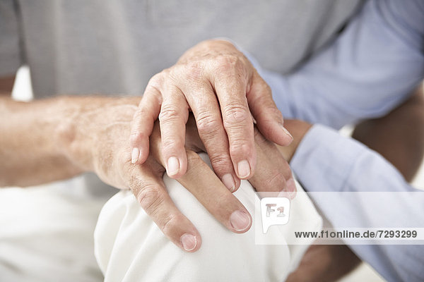 Spain  Senior couple holding hands  close up