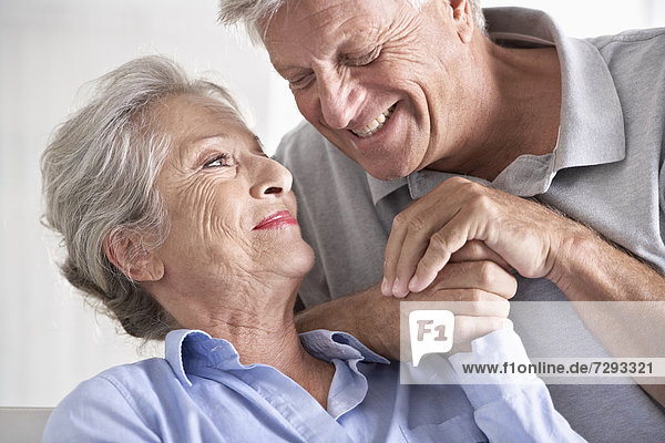 Spain  Senior couple looking at each other  smiling