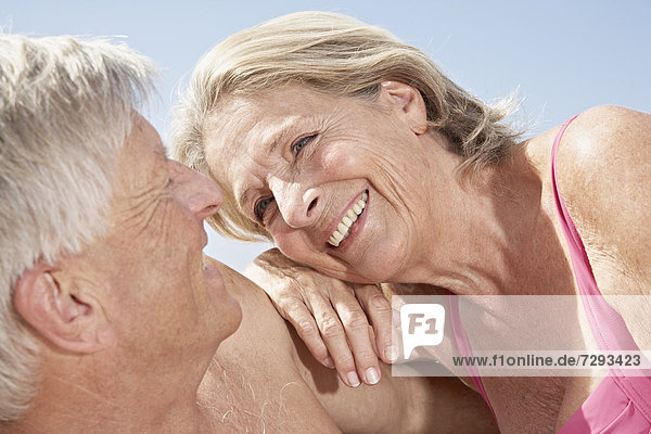 Spain,  Mallorca,  Happy senior couple sitting at beach