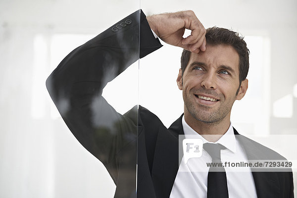 Spain  Businessman standing by door  thinking