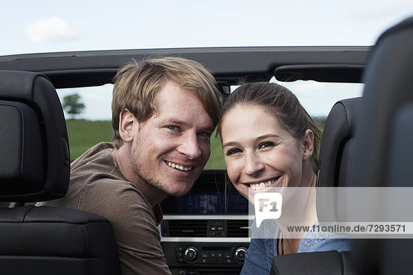 Germany  Bavaria  Couple in car  smiling