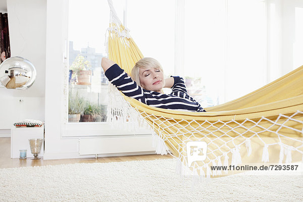 Woman relaxing in hammock