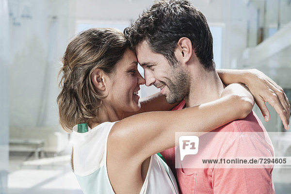 Spain,  Mid adult couple embracing,  smiling