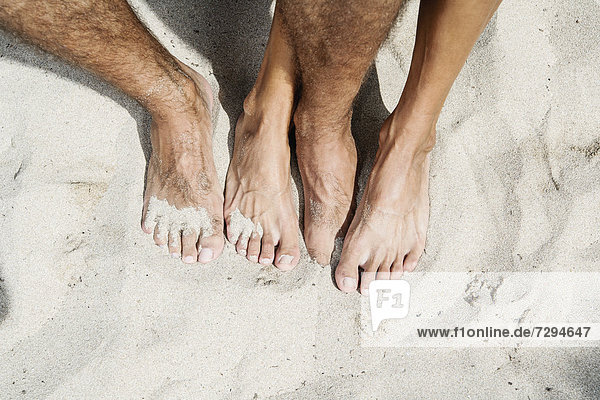 Spain  Mid adult couple legs on beach