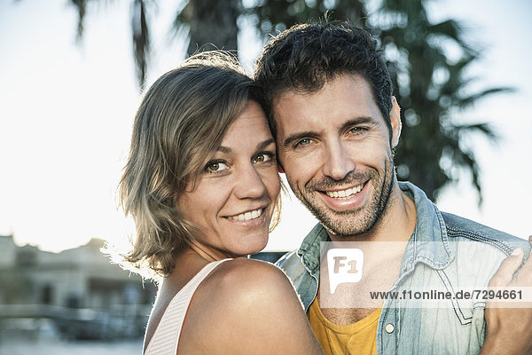 Spain  Mid adult couple embracing  smiling
