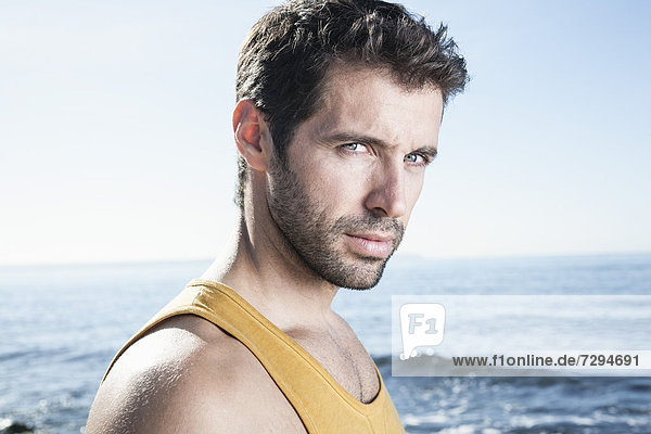 Spain  Mid adult man at Atlantic Ocean  portrait