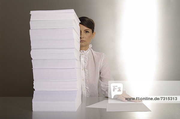 Businesswoman aged 24 making notes at a silver desktop
