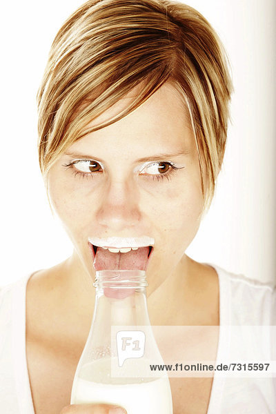 Woman with bottle of milk and milk mustache