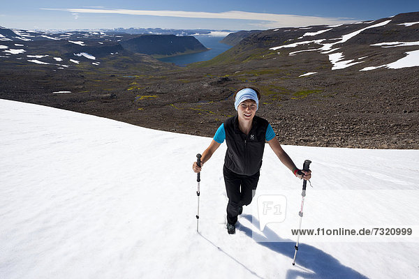 Young woman with walking poles  Hornstrandir  Western Iceland  Iceland  Europe