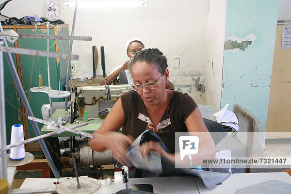 Seamstress working at a small sewing shop in Cienfuegos  Cuba  Caribbean  Americas