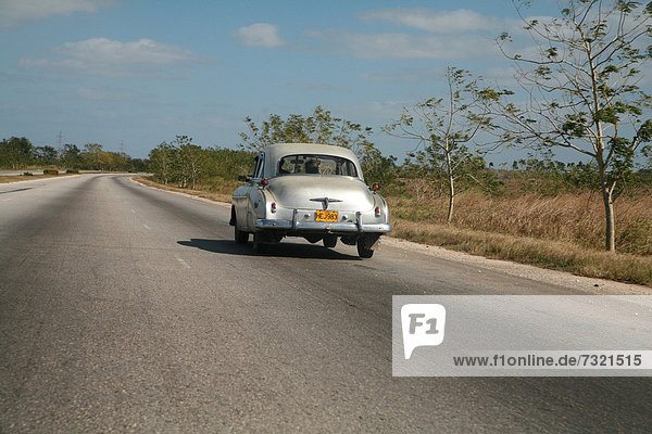 Vintage car driving along the autopista from Vinales to Havana  Cuba  Caribbean  Americas