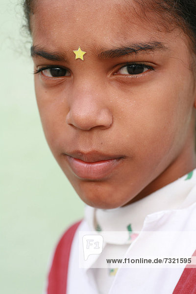 Schoolgirl wearing a gold star on her forehead  Trinidad  Sancti-Spiritus Province  Cuba  Latin America