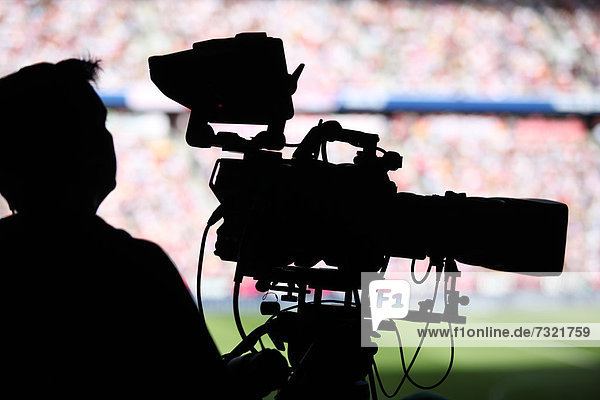 Cameraman in a stadium during a football match