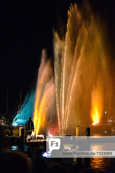 Colourful illuminated fountains at the Harbour Festival in Maasholm  Schleswig-Holstein  Germany  Europe