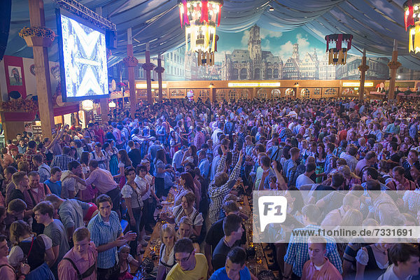 Party in a beer tent Cannstatter Wasen fairground funfair Bad Cannstatt Stuttgart Baden-Wuerttemberg Germany Europe