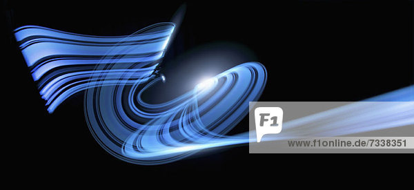 Light trails creating an abstract blue wave pattern on a black background