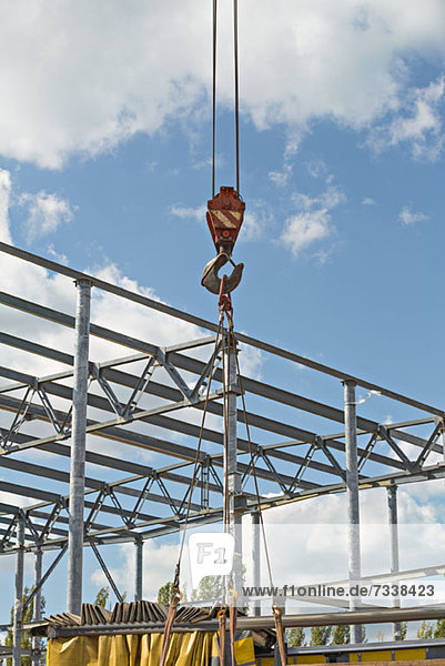Crane hook with construction site in background