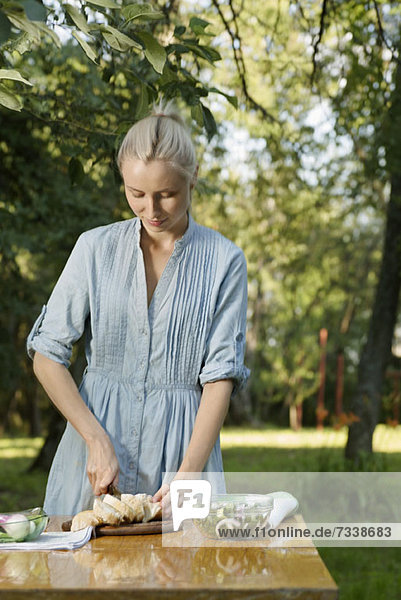 A woman preparing a healthy meal outdoors in the backyard