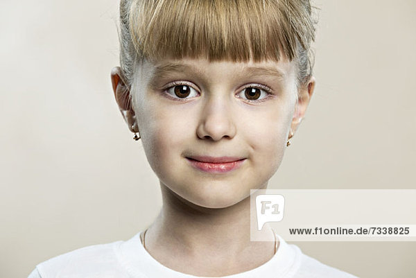 A serene young girl with large brown eyes
