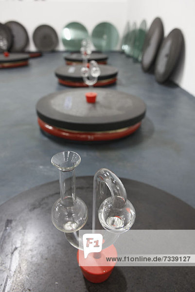 A mix of old and new  lab glassware on top of buried amphora fermenting wine