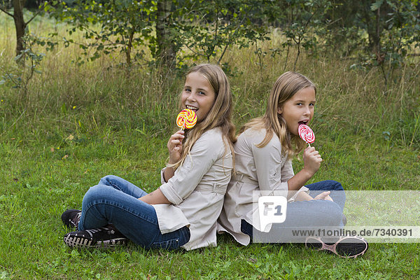 Twin girls  9  with colourful lollipops