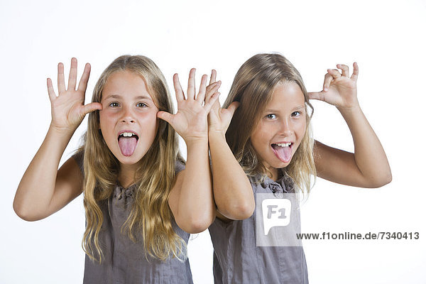 Twin girls  9  making grimaces