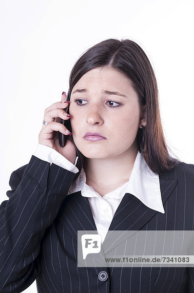 Geschäftsfrau beim Telefonieren  traurig