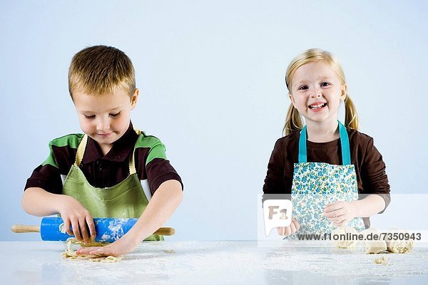 boy and girl kneading dough