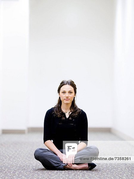 businesswoman sitting cross_legged on the floor